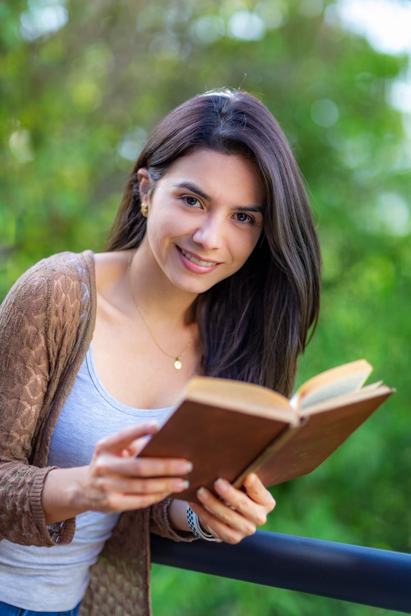 Woman reading outdoors, representing reflective learning and guided discovery